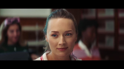 a woman with blue eyes is looking at the camera