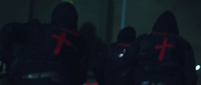 a group of people in black jackets with red crosses on them