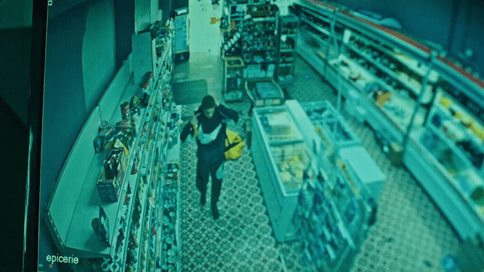 a woman is walking through a store aisle