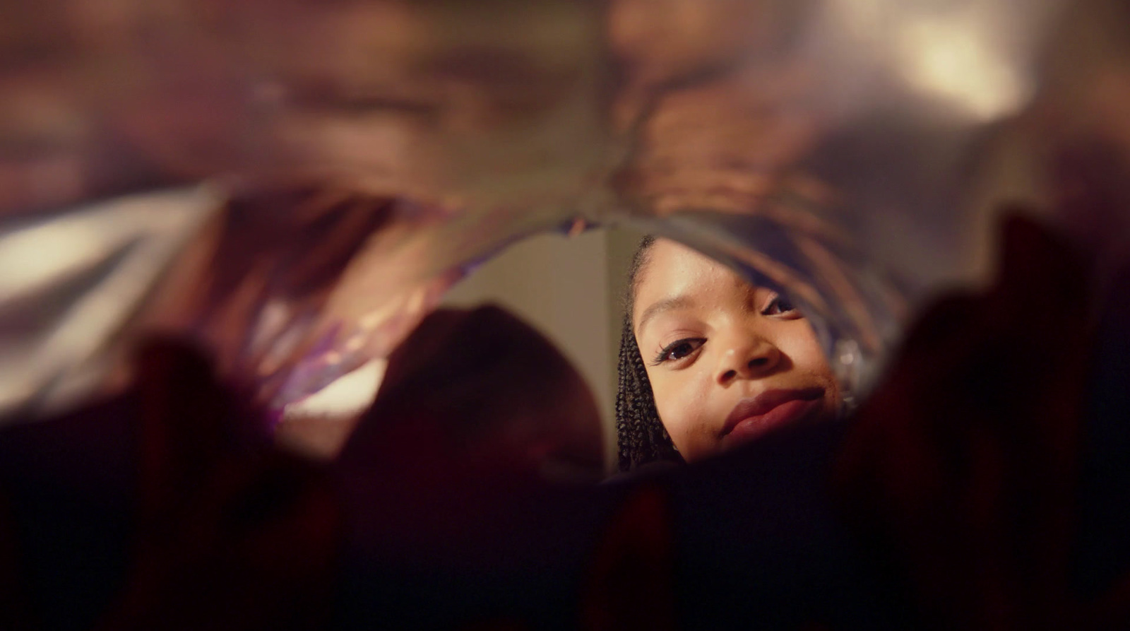 a little girl looking at herself in a mirror