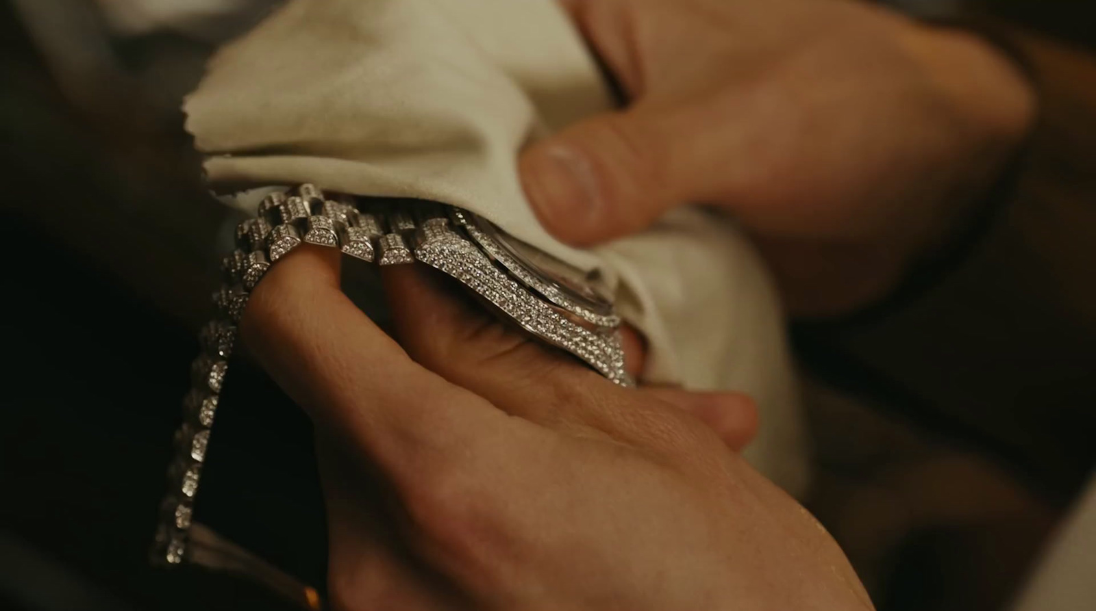 a close up of a person putting a ring on a napkin