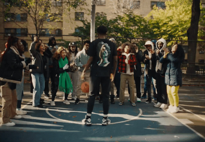 a man riding a skateboard across a basketball court