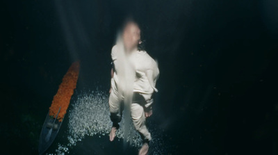 a blurry image of a man in white