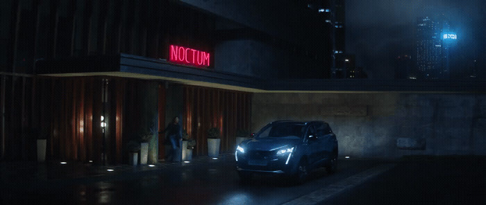 a car parked in front of a building at night