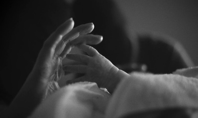 a woman holding a baby in her arms