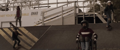 a group of young men riding skateboards down a ramp