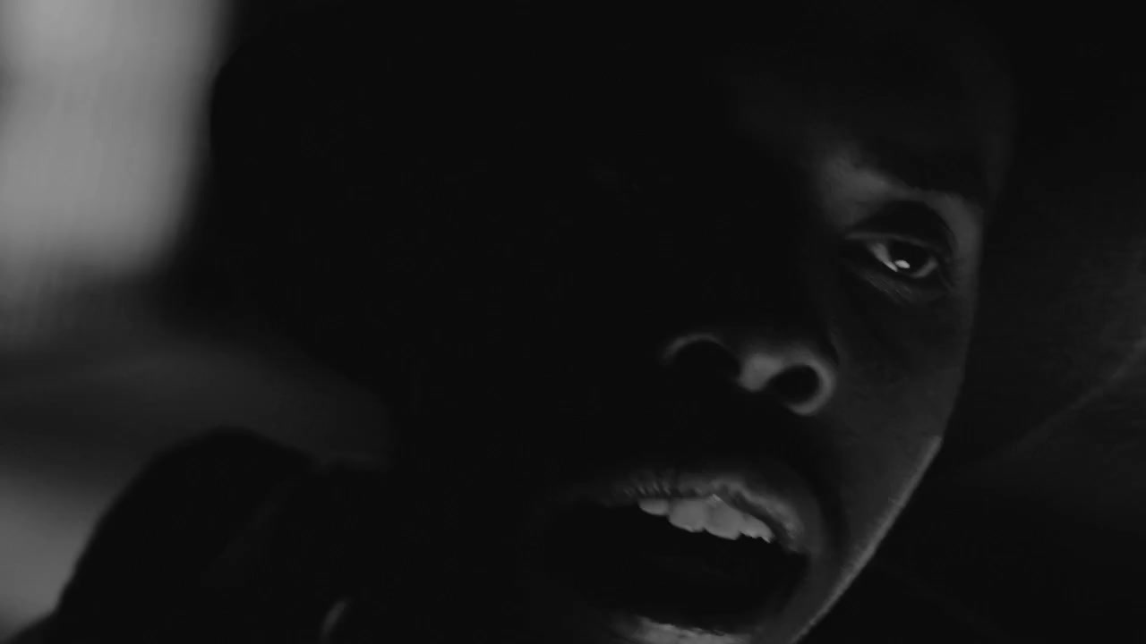 a man in a dark room with his mouth open