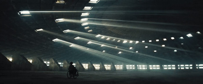 a man riding a bike through a dark tunnel