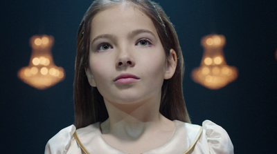 a young girl with long hair wearing a white dress