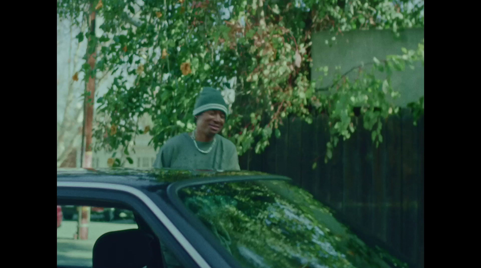 a man standing next to a parked car