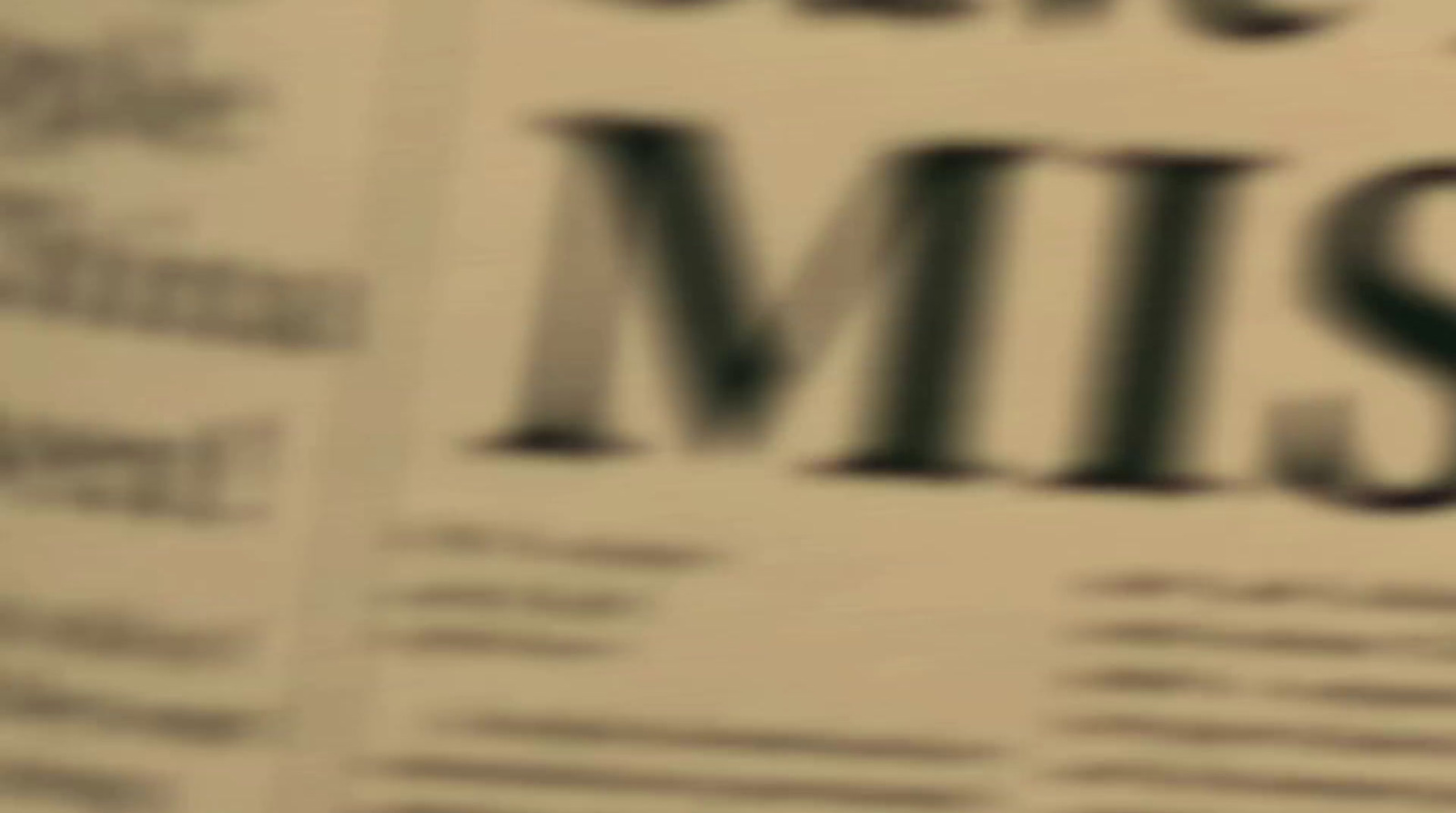 a close up of a newspaper with the word missing