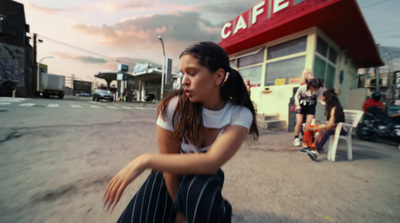 a young woman riding a skateboard down a street