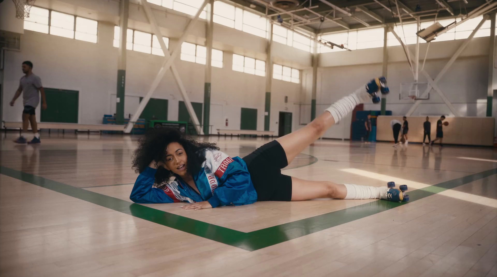 a woman laying on the floor in a gym