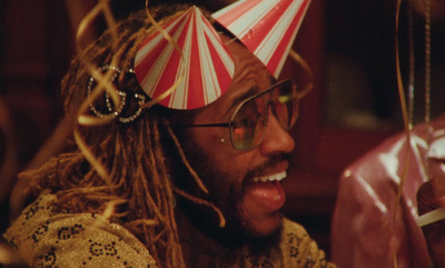 a man wearing a party hat and glasses