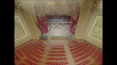 a large auditorium filled with lots of red seats