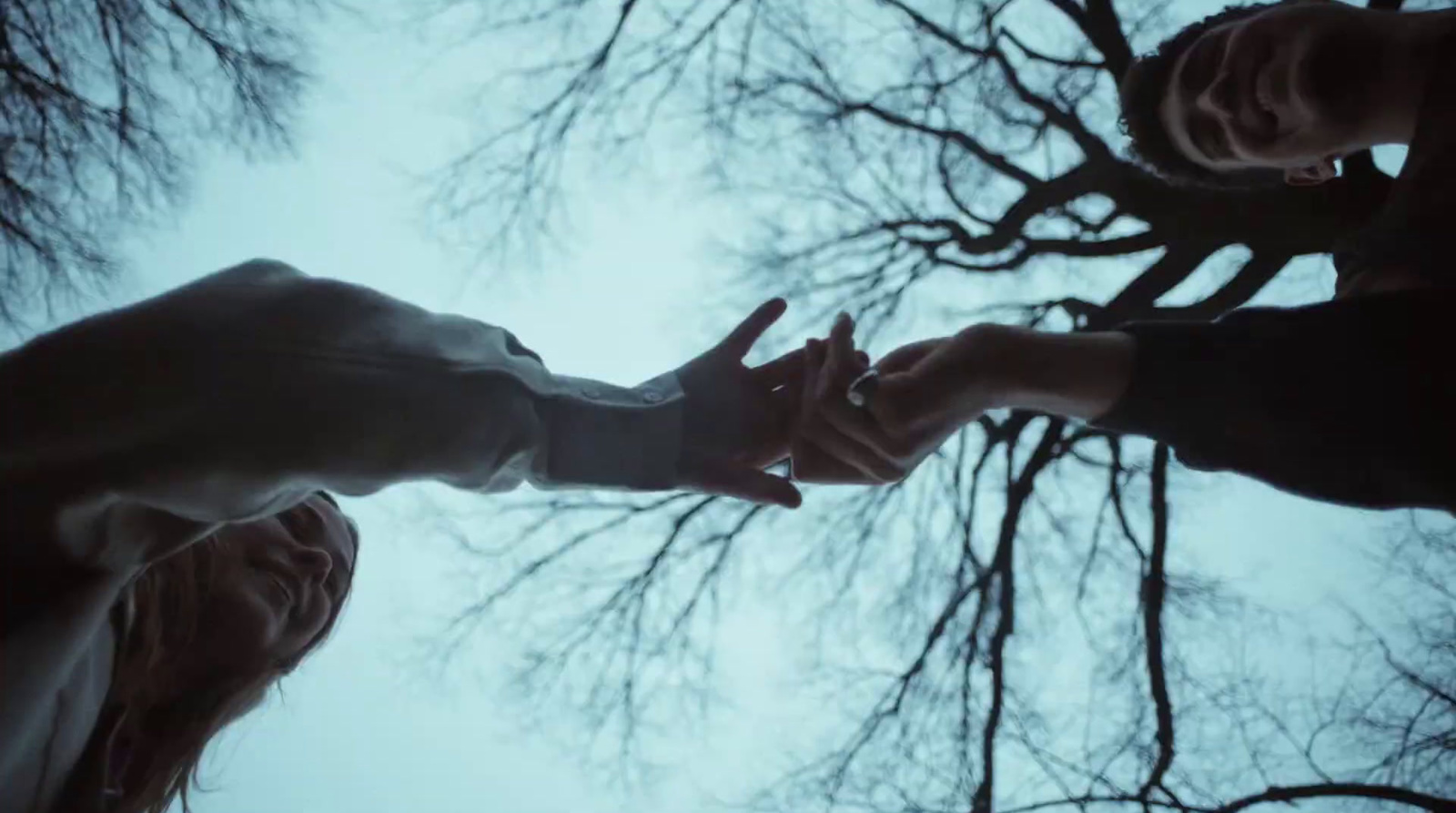 two people reaching out their hands to touch each other