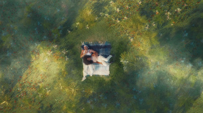 a woman laying in a chair in the middle of a field