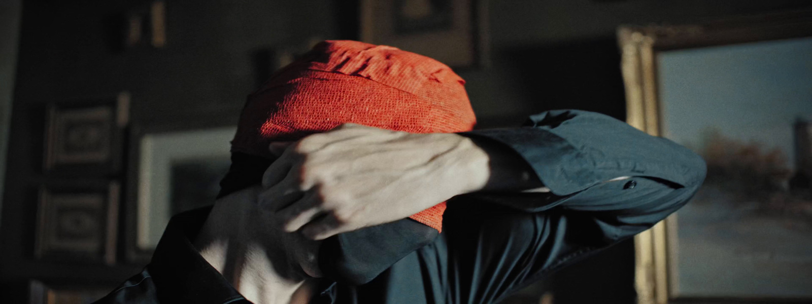 a person with a red hat covering their face