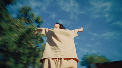 a young man riding a skateboard down a street