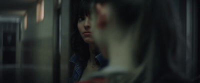 a woman looking out the window of a train