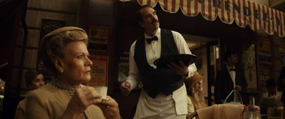 a man and a woman standing in front of a restaurant