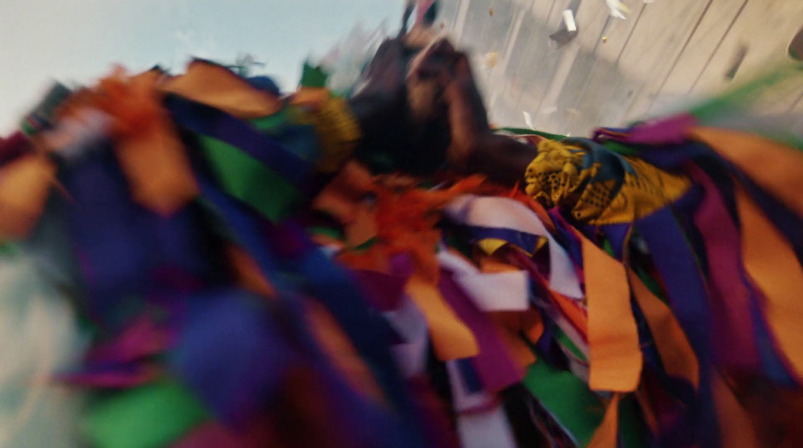 a bunch of colorful streamers hanging from the side of a building