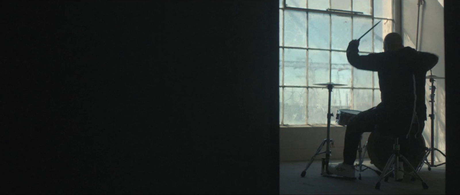 a man sitting in a chair in front of a window