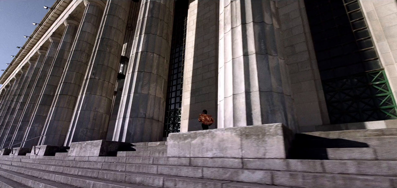 a man riding a skateboard down the side of a set of stairs