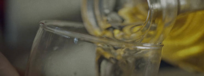 a close up of a glass with a yellow object in the background