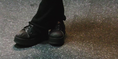 a person wearing black shoes and black pants