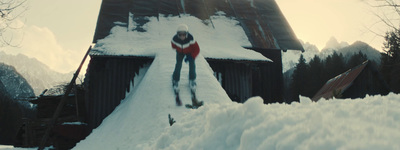 a man riding skis down a snow covered slope