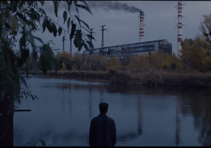 a man standing in front of a body of water