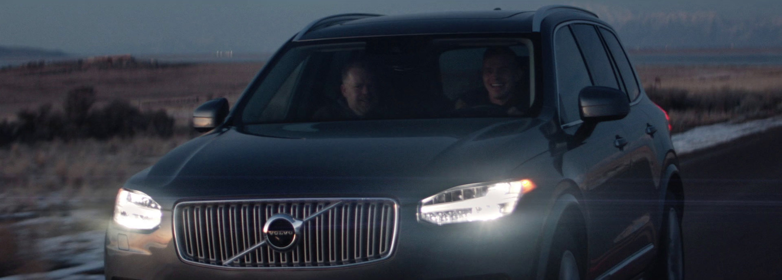 a couple of people in a car driving down a road