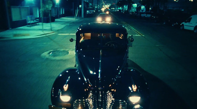 a car driving down a street at night