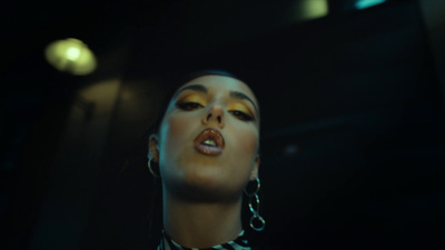 a woman in a black and white striped shirt and earrings