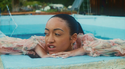 a woman laying in a pool with a surprised look on her face