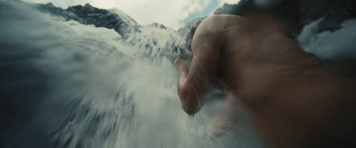 a blurry photo of a man surfing in the ocean