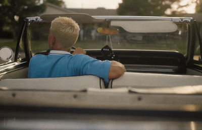 a man sitting in the back of a pick up truck