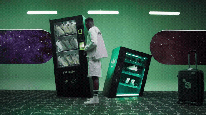 a man standing next to two vending machines