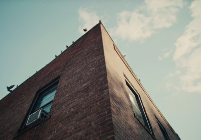 a tall brick building with a sky background