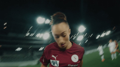 a female soccer player in a red uniform