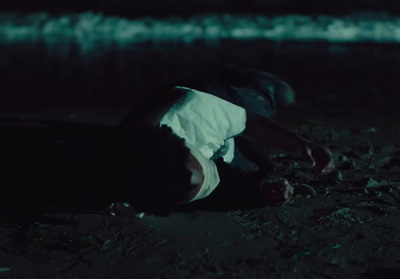 a person laying on the ground in the dark