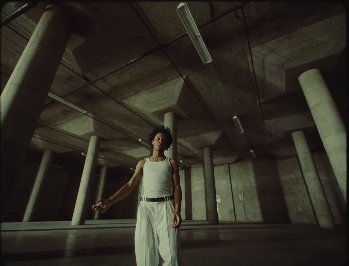 a woman standing in a large room with columns