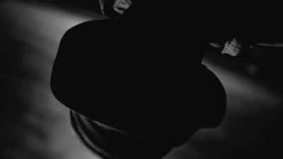 a black and white photo of a person holding a skateboard