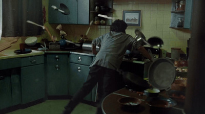 a man standing in a kitchen preparing food