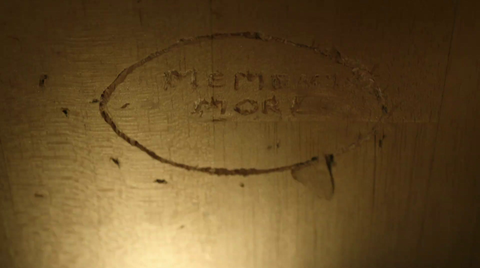 a close up of a wooden surface with writing on it