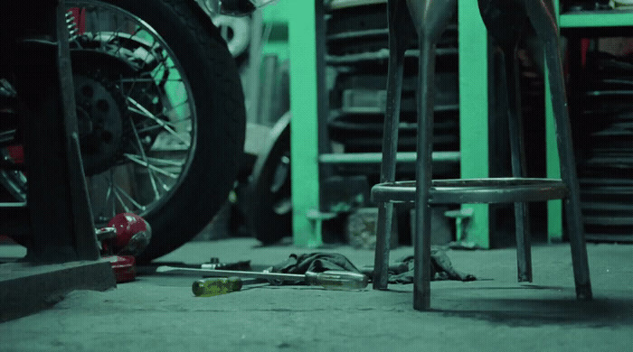 a motorcycle tire and a chair in a garage