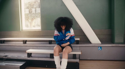 a woman sitting on a bench in a building