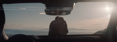 a person sitting in the passenger seat of a car