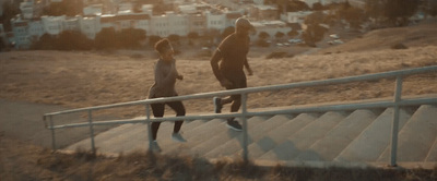 a couple of people walking up a set of stairs